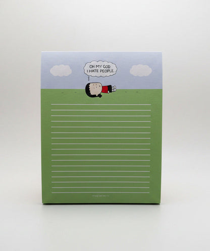 A square notepad with a cartoon illustration of a sheep at the top and a lined writing area below, photographed on a plain light gray background.