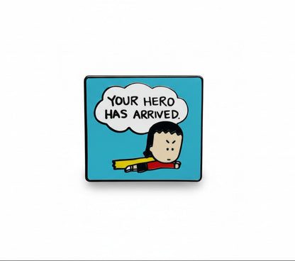 Enamel pin with Kim, the Angry Little Asian Girl, a cartoon character and text 'Your hero has arrived' on a blue background