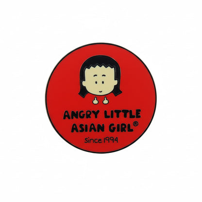 A pin with a red background featuring Kim, the Angry Little Asian Girl, a cartoon character and the text 'ANGRY LITTLE ASIAN GIRL Since 1994'.